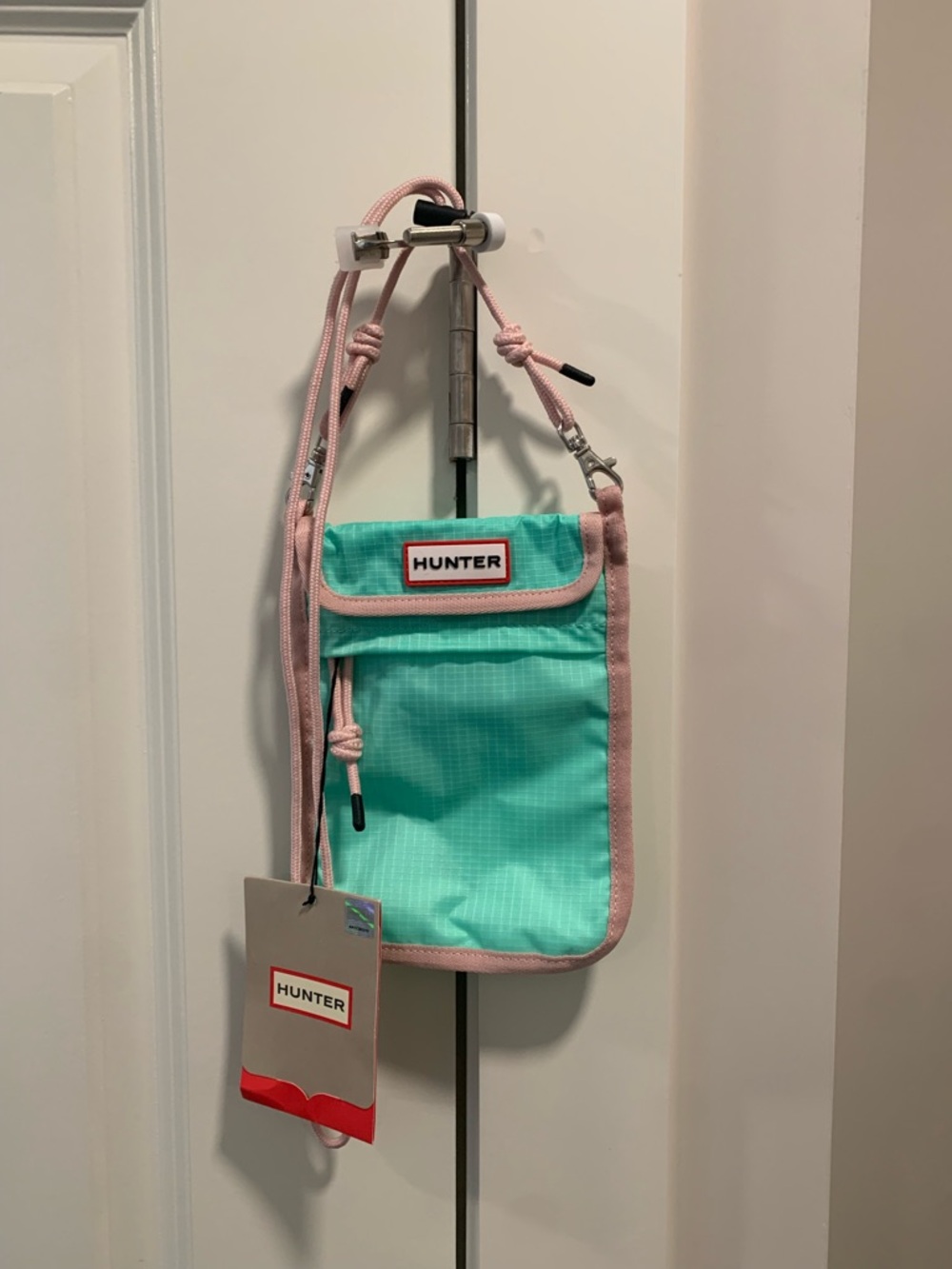 NWT- HUNTER .  Mint Green Crossbody  Pouch with Pink Trim. Good  for traveling.
